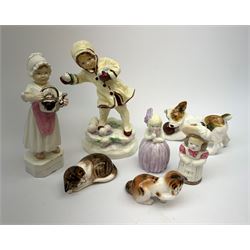 A group of Royal Worcester and Royal Doulton figures, comprising Royal Worcester, December modelled by F G Doughty 3458, polly put the kettle on 3303, two candle snuffers Feathered Hat, and Hush, and Royal Doulton, Terrier dog with ball HN1103, and two Kittens HN2581, and HN2583. (7). 
