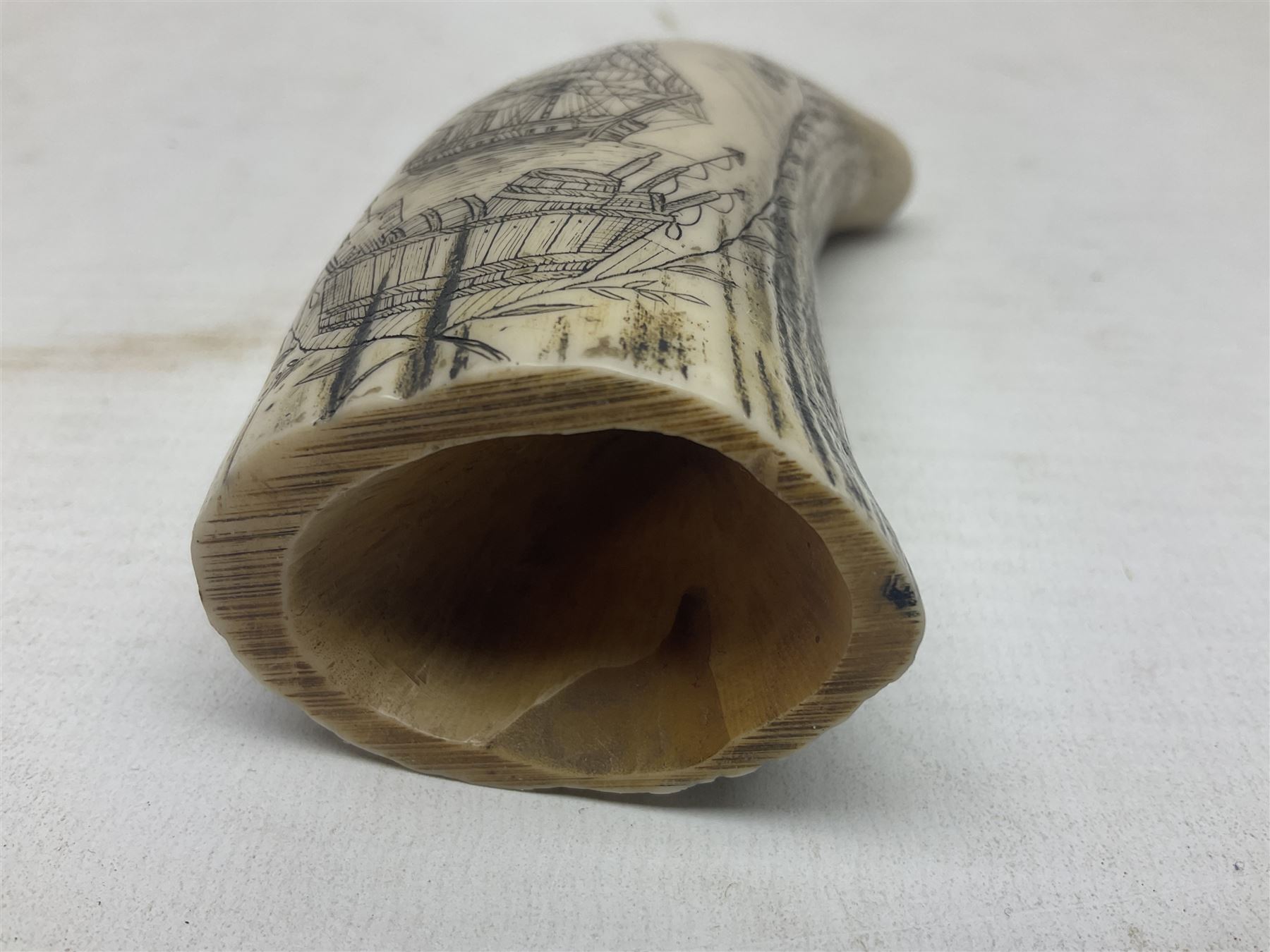 20th century resin carvings in the style of scrimshaws the first example depicting Ship Mercury, the other with a removable top, tallest example H10.5cm