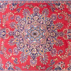 North East Persian Meshed hand-knotted rug, madder red field with central multi-lobbed medallion in shades of indigo, ivory, and sofa pastel tones surrounded by scrolling floral vines, palmettes, stylized blossoms, floral sprays, and cartouches, framed by Indigo spandrels, enclosed within a broad dark blue main border, flanked by multiple narrow guard stripes, with fringe ends 