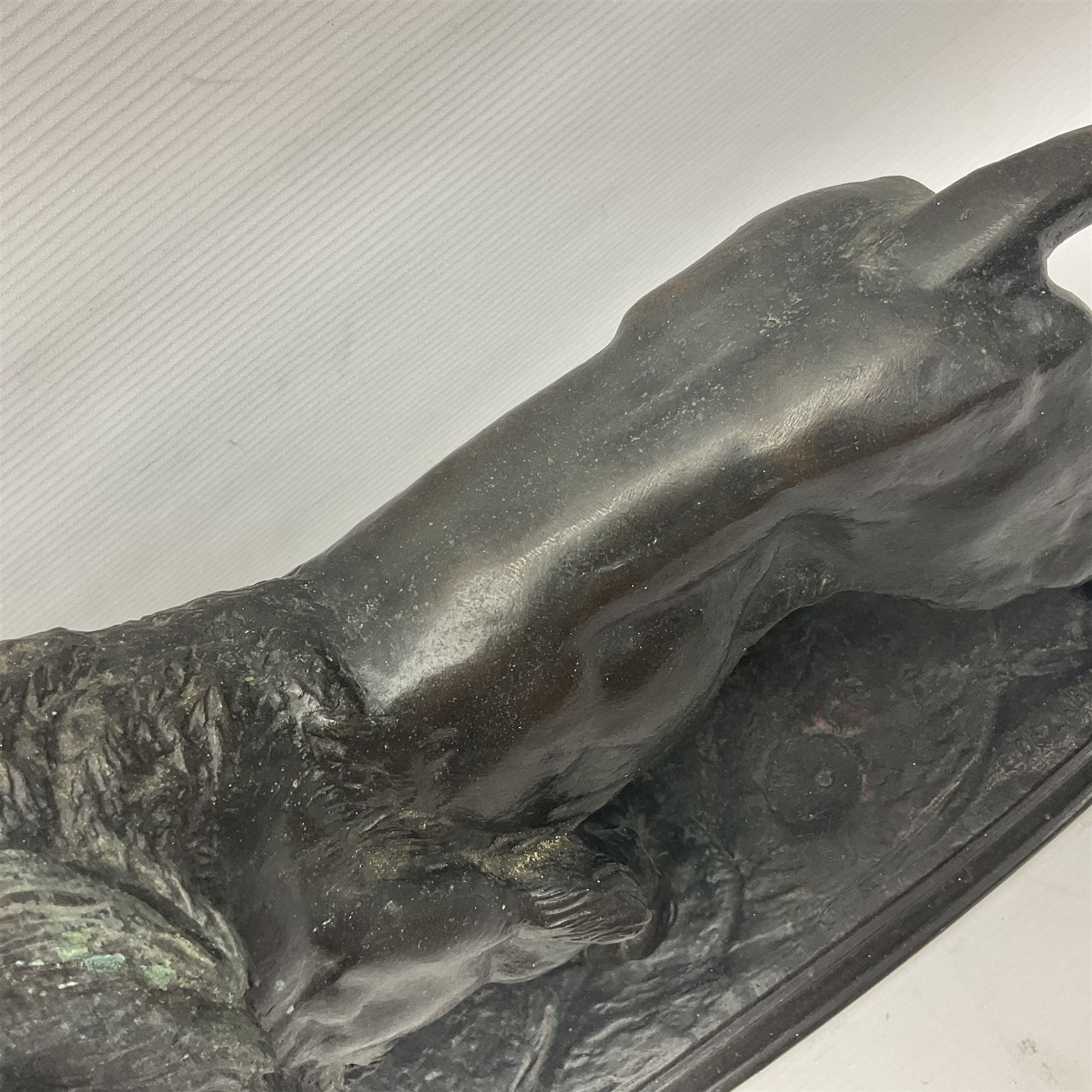 After Paul Edouard Delabrierre (French, 1829-1912), bronze, model of a lion, upon an oval base, signed E Delabrierre, overall H29.5cm, L46cm