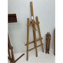 A group of four artist's easels, largest example H150cm. 
