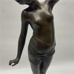 Bronzed semi nude female figure with one hand raised, upon a marble plinth, H43cm  
