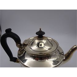 1920s three piece silver tea service, comprising teapot, with ebonised wooden handle and finial, milk jug and open sucrier, all of circular form, with shaped rims, and upon three hoof feet, hallmarked Wakely & Wheeler, London 1922, teapot H19cm