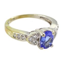 White gold oval tanzanite ring, with diamond set shoulders, stamped 14K