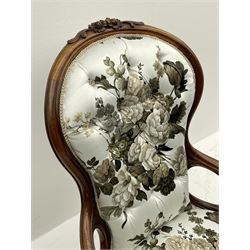 Victorian walnut framed open armchair, moulded spoon back carved with flower heads and foliage, upholstered in buttoned white ground and floral pattern 'Symphony' fabric by Sanderson, shaped scrolled arms above cabriole supports carved with flower heads