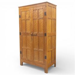 Acornman - oak adzed panelled double wardrobe, with wrought iron hinges and carved oak latch revealing a single clothes rail, with signature carved acorn to top right, by the workshop of Alan Grainger, Brandsby