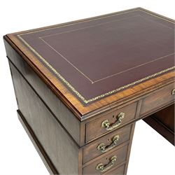 George III mahogany twin pedestal partner's desk, moulded rectangular caddy top with tooled leather inset, one side fitted with nine drawers and the opposing side fitted with single drawer, two false drawers and two panelled cupboards, ornate cast gilt metal handles and handle plates, on plinth base