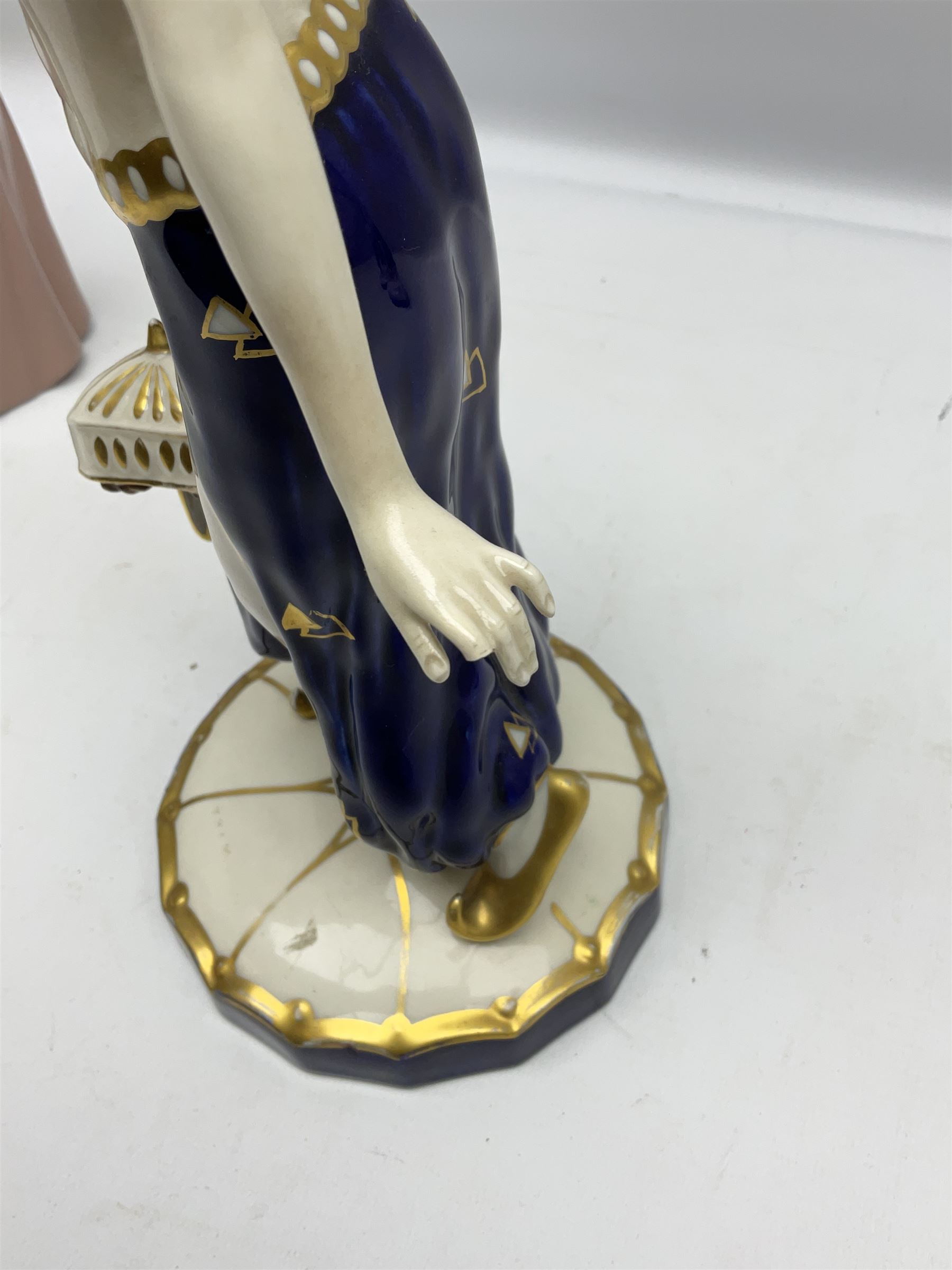 Royal Dux Art Deco figure group of Turkish dancing girl with a young boy beside her holding a casket, decorated with gilding, raised upon scalloped edge plinth base, with applied pink triangle and impressed 2948 beneath