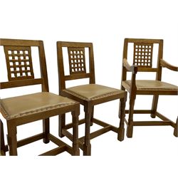 'Rabbitman' set of eight oak dining chairs, pierced lattice backs, upholstered seats with studwork band, octagonal front supports joined by stretchers, carved with rabbit signature, two carvers and six side chairs, by Peter Heap of Wetwang
