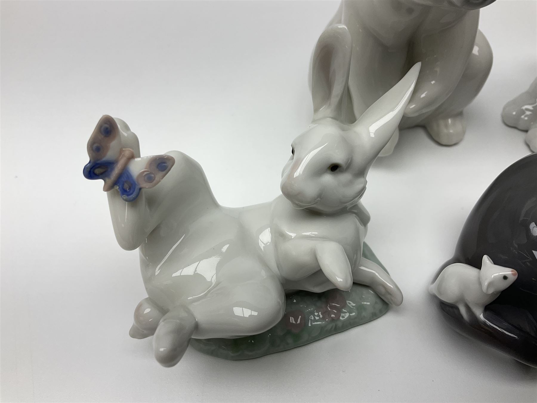 Five Lladro figures, comprising Cat and Mouse no. 5236, That Tickles no. 5888, Gentle Surprise no. 6210, Little Hunter no. 6212 and Resting Polar Bear no. 1208, largest H12cm