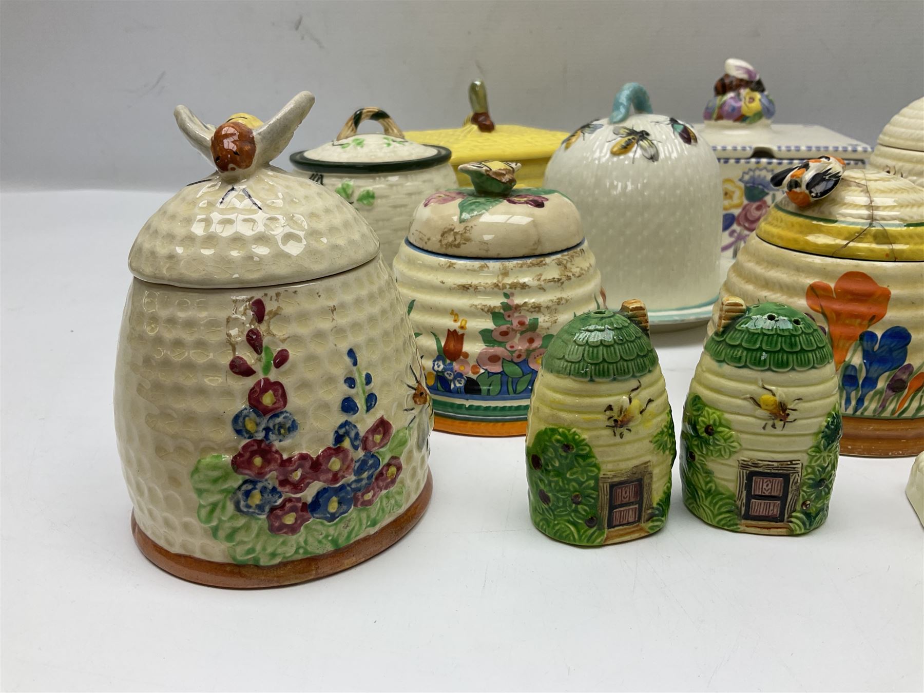 Clarice Cliff for Wilkinson Ltd Crocus Bizarre beehive honeypot painted in the Crocus pattern, together with two beehive Beswick honey pots, Poole square honey pot etc (14)