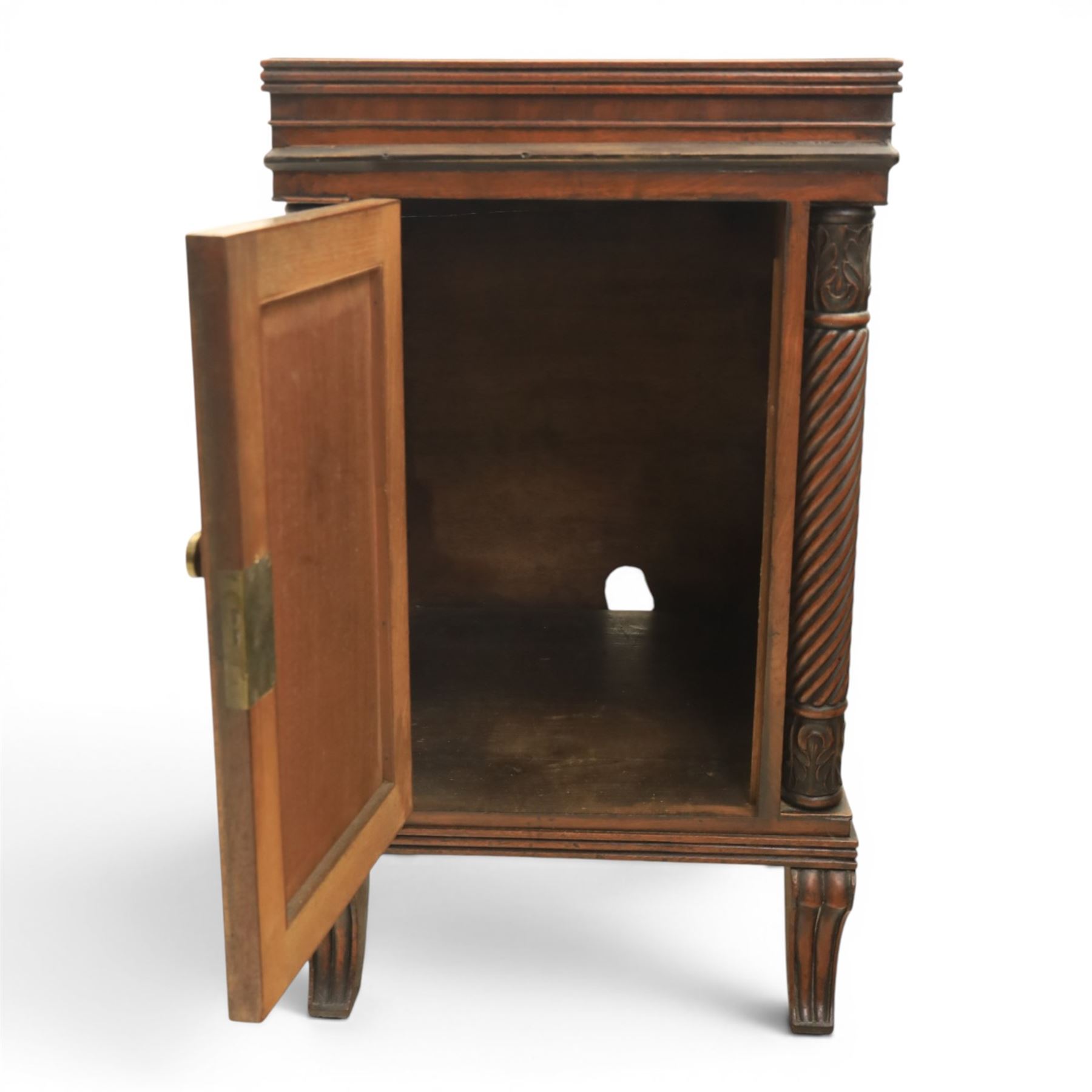 Pair of Regency mahogany bedside cabinets, rectangular top above a central cupboard door with flame mahogany veneer, flanked by spirally turned column uprights, raised on shaped supports