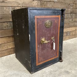 Samuel Withers & Co of West Bromwich - Victorian cast iron safe, the brass handle modelled as a clenched fist, painted in red, orange and black, with key. Ground floor delivery only, no steps.