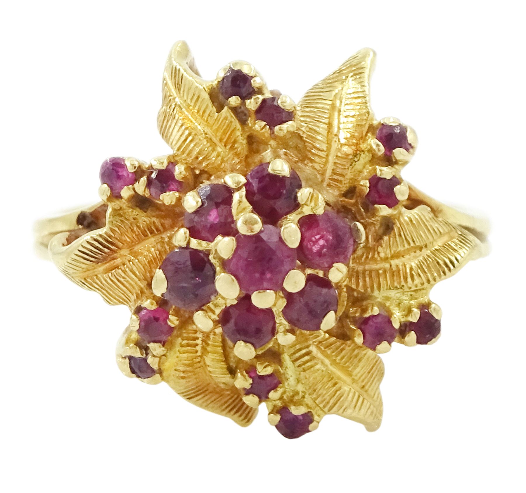 18ct gold ruby flower head cluster ring, seven round cut rubies surrounded by textured leaves, each spaced by two rubies, stamped 750