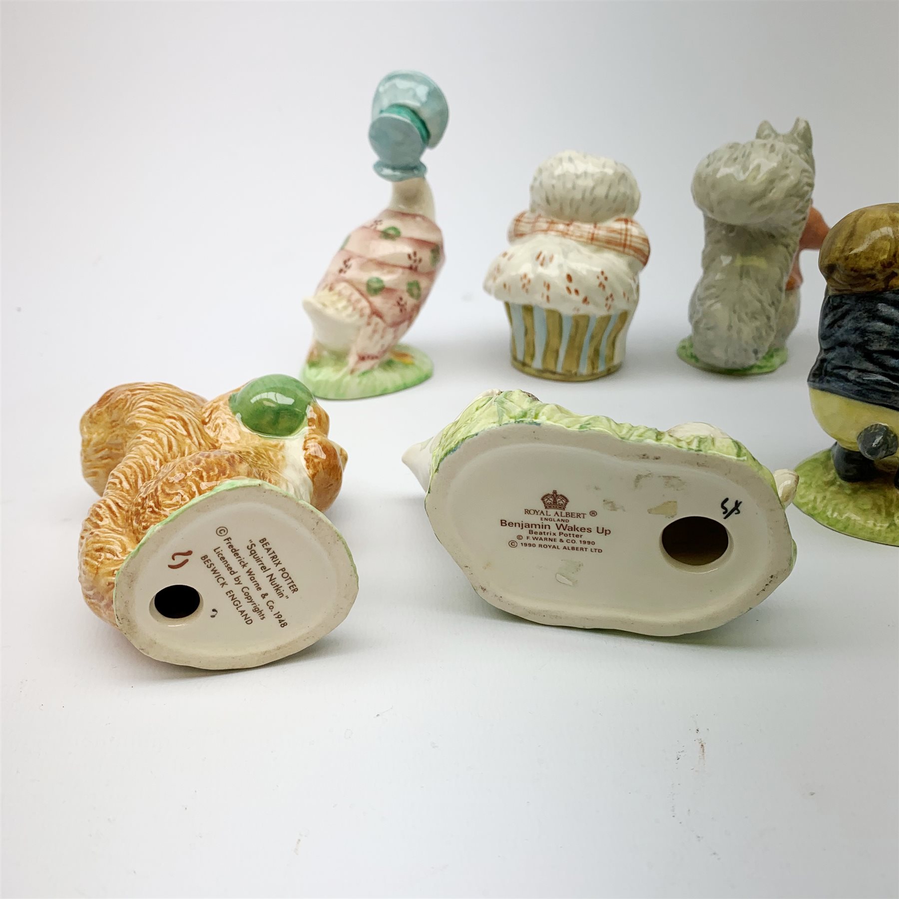 Five Beswick Beatrix Potter figurines, comprising Tommy Brock, Mrs Tiggy Winkle, Jemima Puddleduck, Foxy Whiskered Gentleman, and Squirrel Nutkin, together with four Royal Albert Beatrix Pottery figurines, Comprising Tommy Tiptoes, Benjamin Wakes Up, Peter Rabbit, and Mr Alderman Ptolemy. 