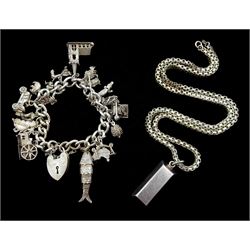 Silver curb link bracelet, with heart locket clasp and twenty-one silver charms including articulated fish, koala bear, alligator, wedding church and monkey and a fine silver ingot, on silver chain