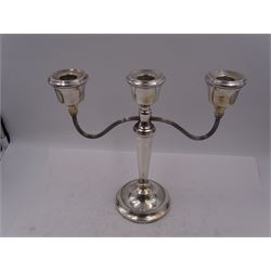 Modern silver mounted three branch candelabra, the tapering stem supporting a central candle holder and two curved branches with candle holders, upon weighted stepped circular foot, hallmarked A T Cannon Ltd, Birmingham 1973, H22.5cm