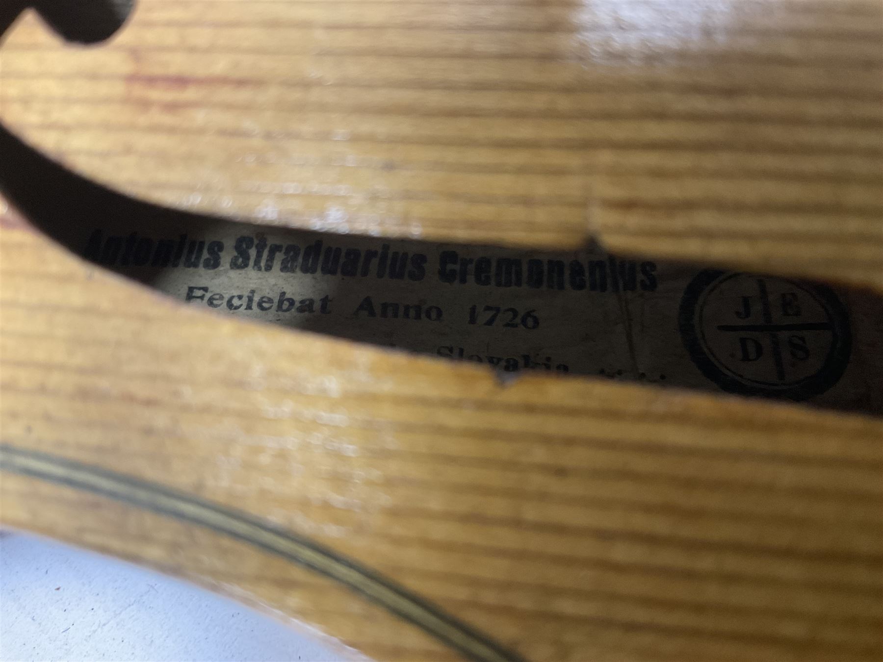 Copy of a full size Stradivarius violin, with an ebonised fingerboard, tailpiece and tuning pegs Length 60cm
