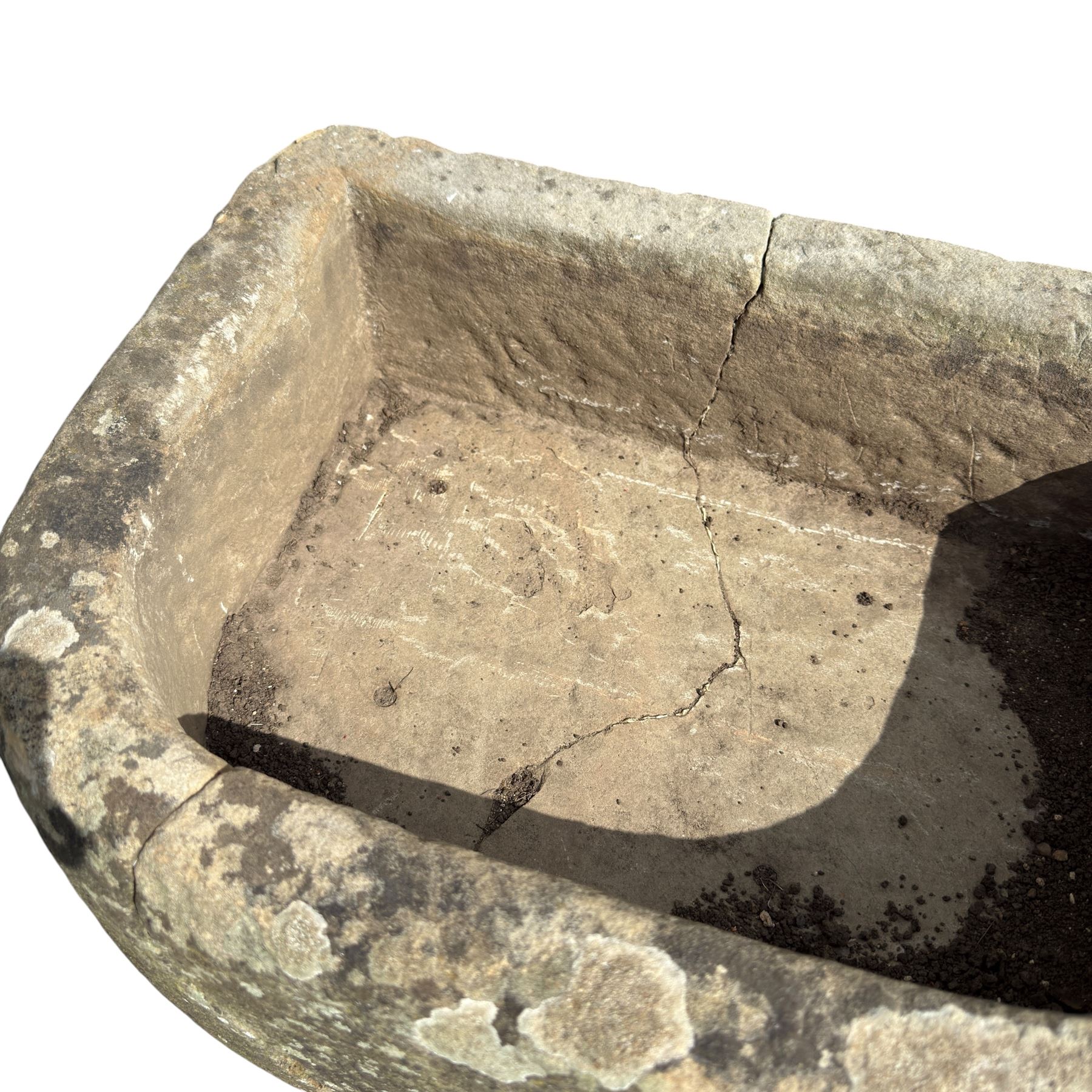 19th century hewn sandstone trough of D shaped form, in weathered finish
