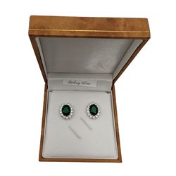 Pair of silver cubic zirconia and green stone oval cluster stud earrings, stamped 925, boxed 