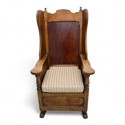19th-century beech, yew, elm, and mahogany wingback vernacular rocking chair, high back with shaped wings, scroll arms with turned supports, lift-up seat,  square legs on ring turned supports on curved runners 