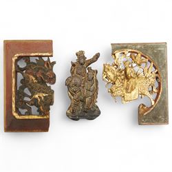 Chinese devotional woodcarvings, depicting a warrior riding a dragon and an elephant, and ...
