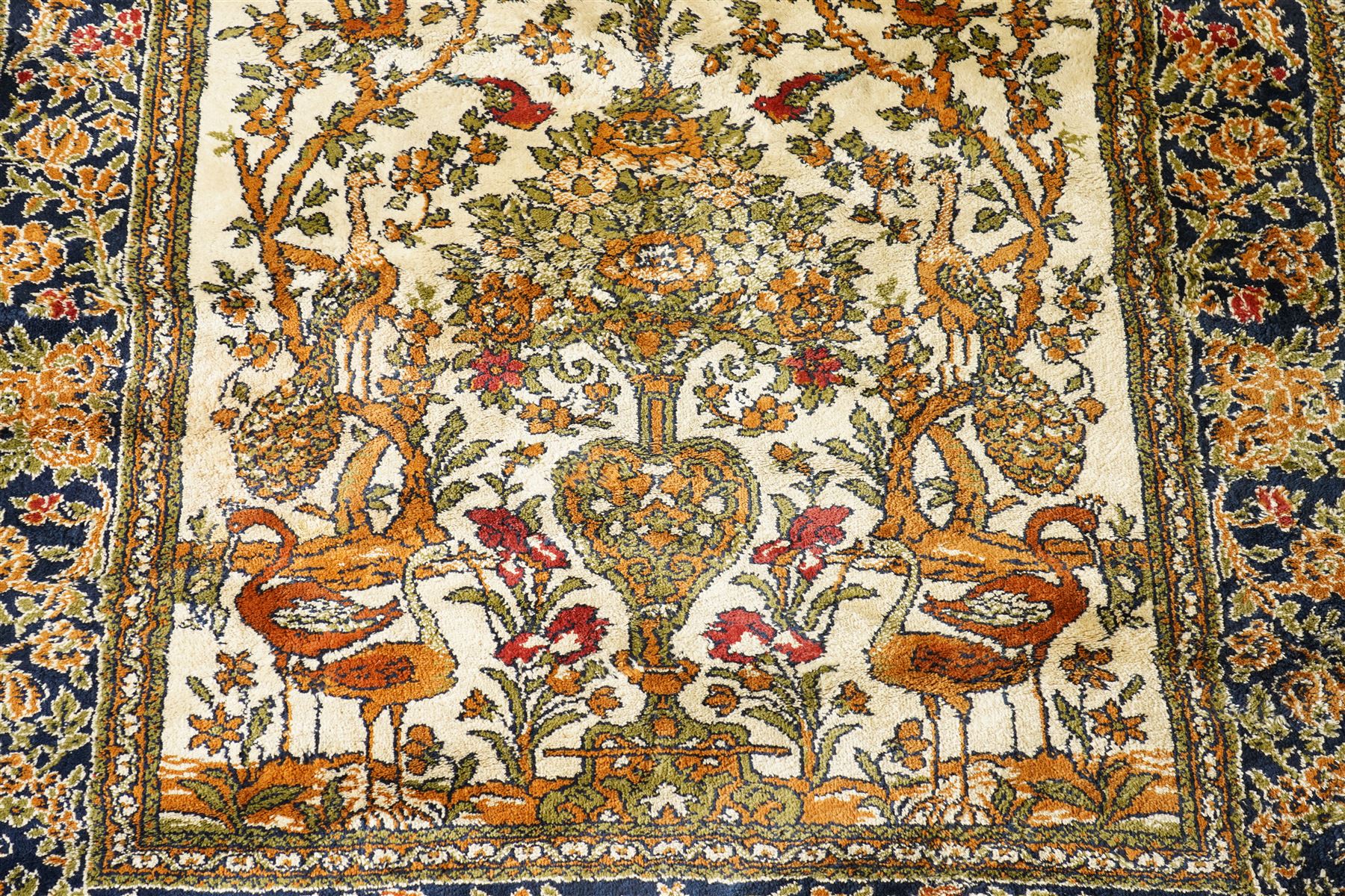 Kashan style rug, twin peacocks flanking a large decorative urn, motifs tree of life style, multiple borders with fine floral patterns 