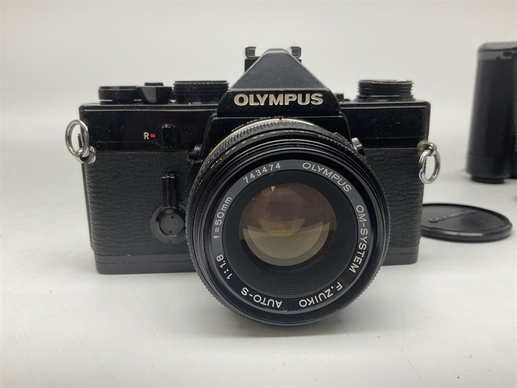 Olympus OM-1 camera body, serial no 913212, with 'Olympus OM-System F.Zuiko Auto-S 1:1.8 f=50mm' lens, serial no.74374, 'Vivitar wide angle MC 28mm 1:2.8 49mm' lens, serial no. 42042268, and Olympus OM winder 2