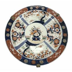 Japanese Imari charger, late 19th/early 20th century, decorated with a central circular panel of flowers arranged in twin handled vase, surrounded by four lattice and larger panels painted with floral sprays and trees and stylised foliate border, W37cm