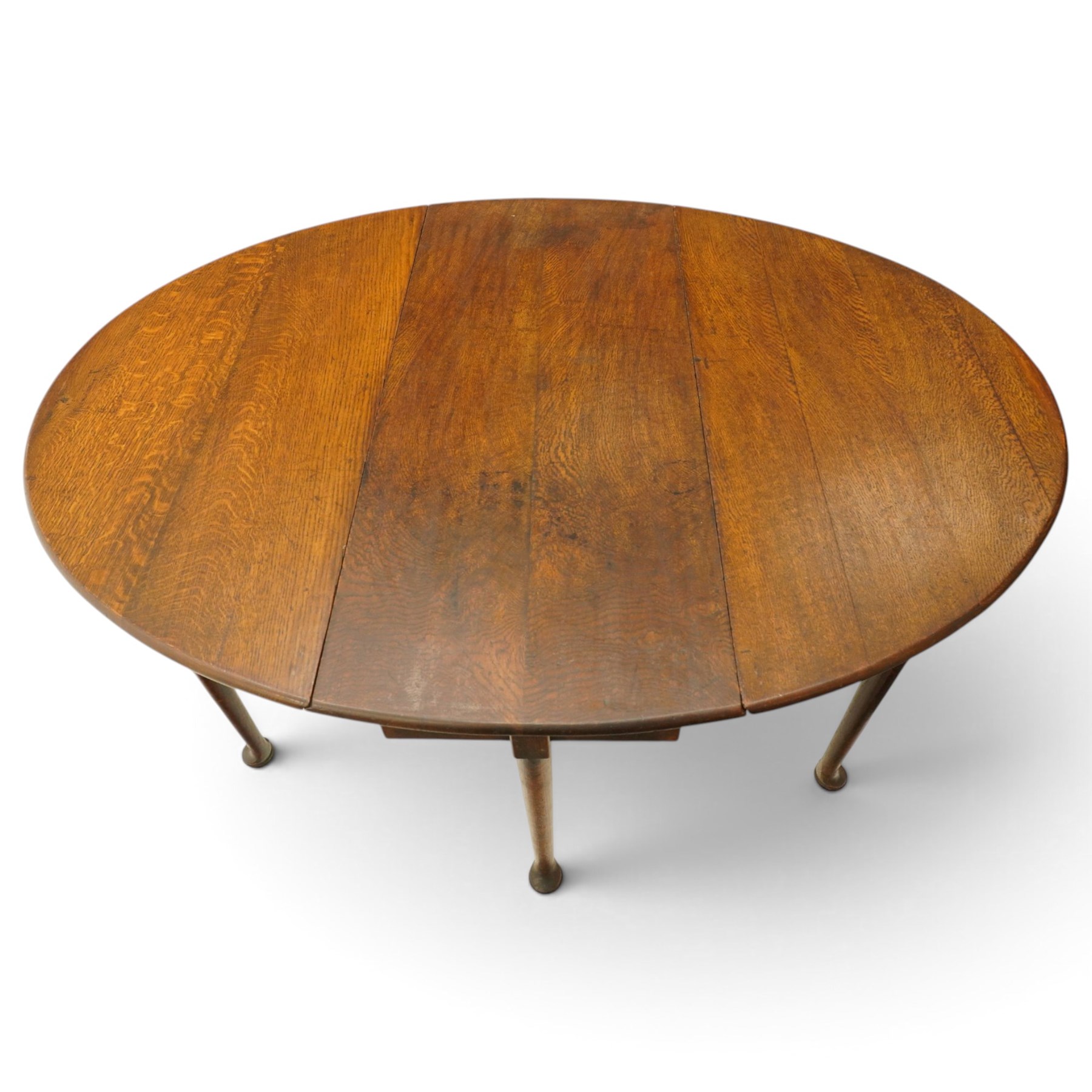 George III oak six-legged drop-leaf dining table, the oval drop-leaf top over six gate-leg supports with pad feet