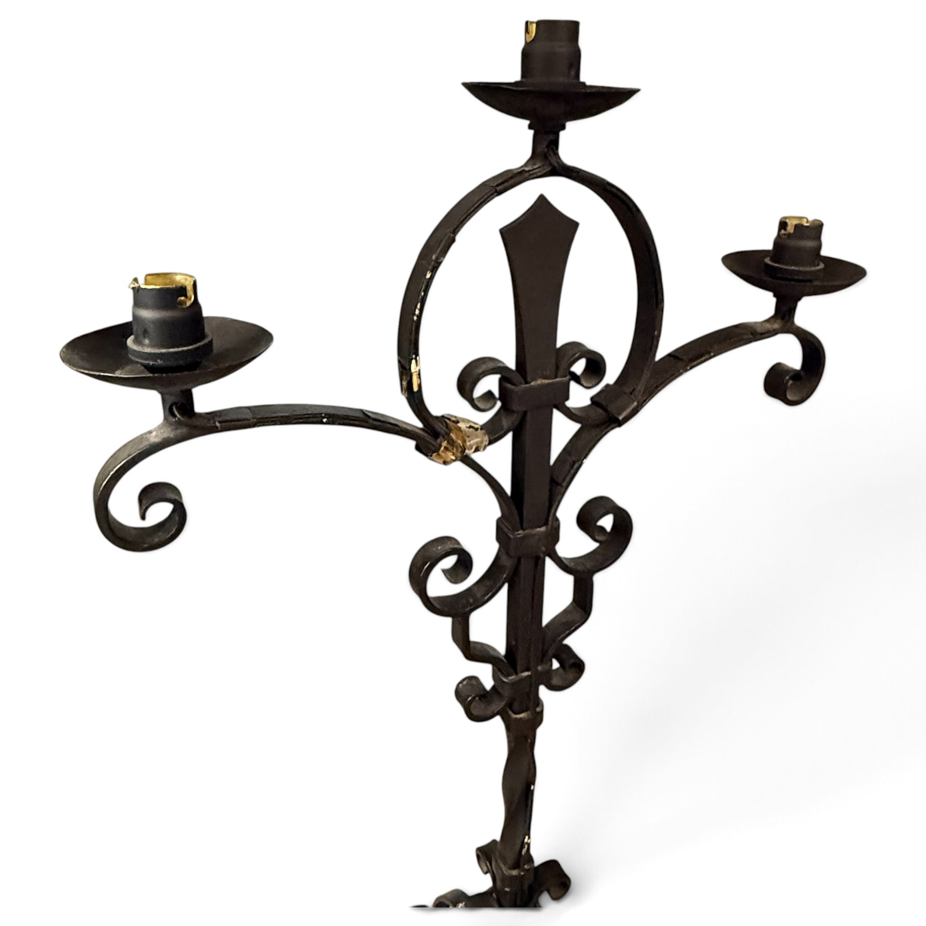 Collection of wrought iron candle stands, comprising five-light and three-light floor-standing candelabra with scrolling branches, and a pair of five-light table candelabra of naturalistic branching form
