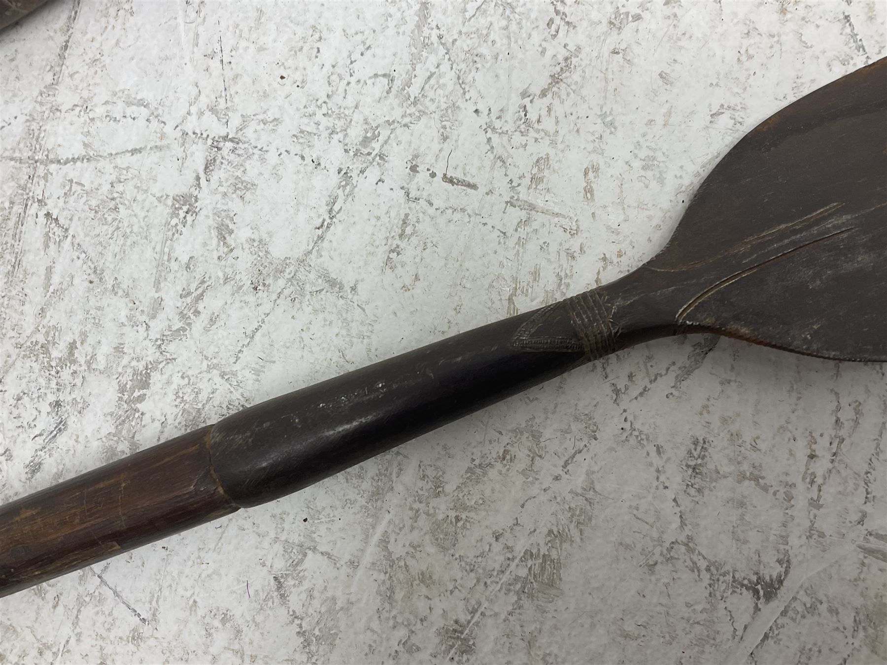 Native long-shafted spear, the large iron head with central medial ridge and decorative neck, on plain circular haft L260cm; and another similar Native long-shafted spear with cane haft L249cm (2)