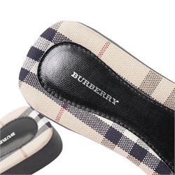 Christian Louboutin and Burberry - two pairs of designer shoes, comprising black leather Christian Louboutin low-top sneakers with black spike-studded toe caps and signature red soles, size 40, with dust bag, together with Burberry check canvas and red transparent strap sandals, size 39, with box and dust bag (2)