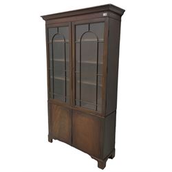 Late 19th century mahogany bookcase on cupboard, fitted with two glazed doors above two cupboards, adjustable shelves