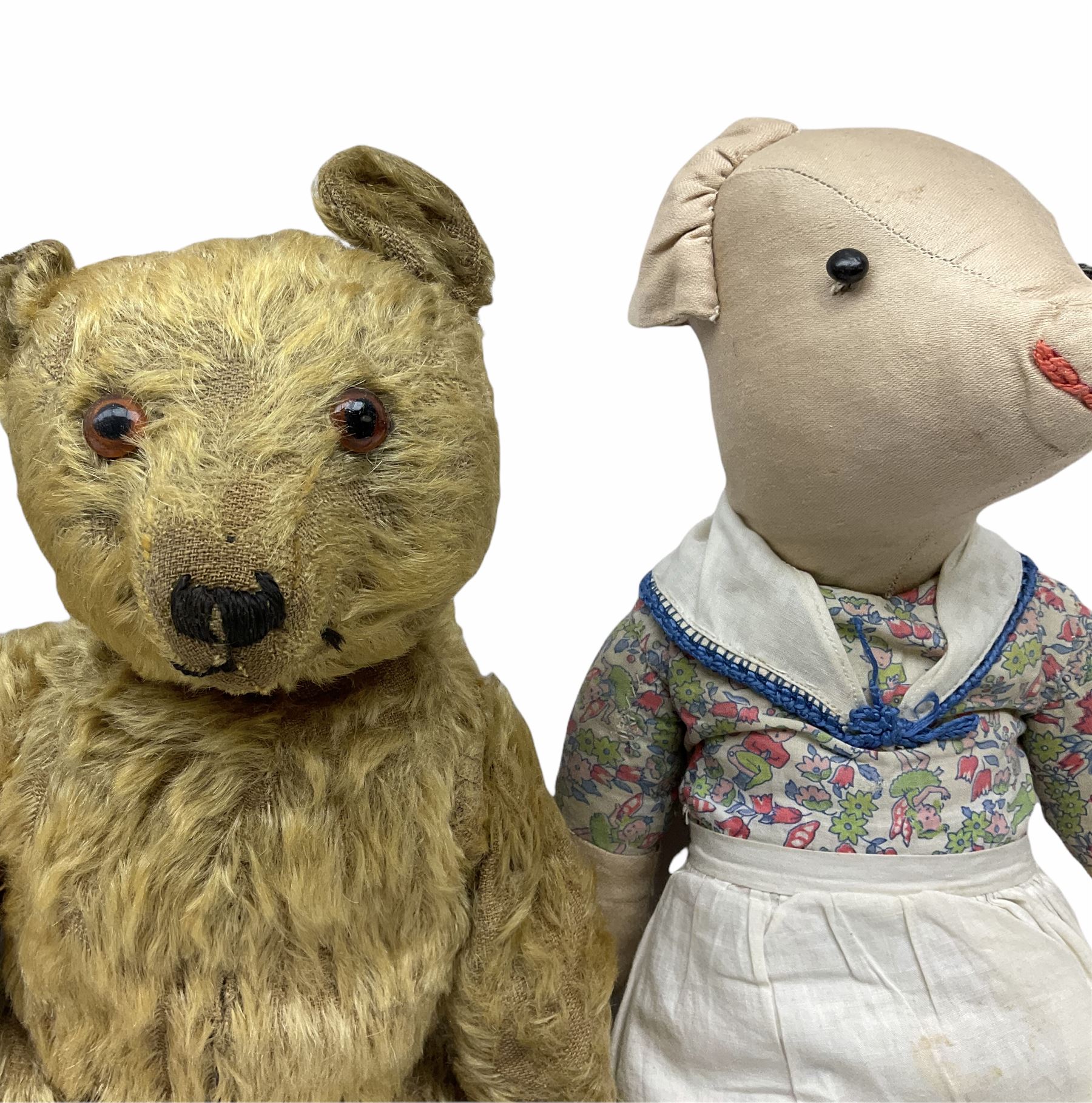 1950's teddy bear with jointed limbs, revolving head, wood filled body, stitched nose and mouth, applied glass eyes and foot pads, together with a quantity of handmade soft toy rabbits and penguins. 