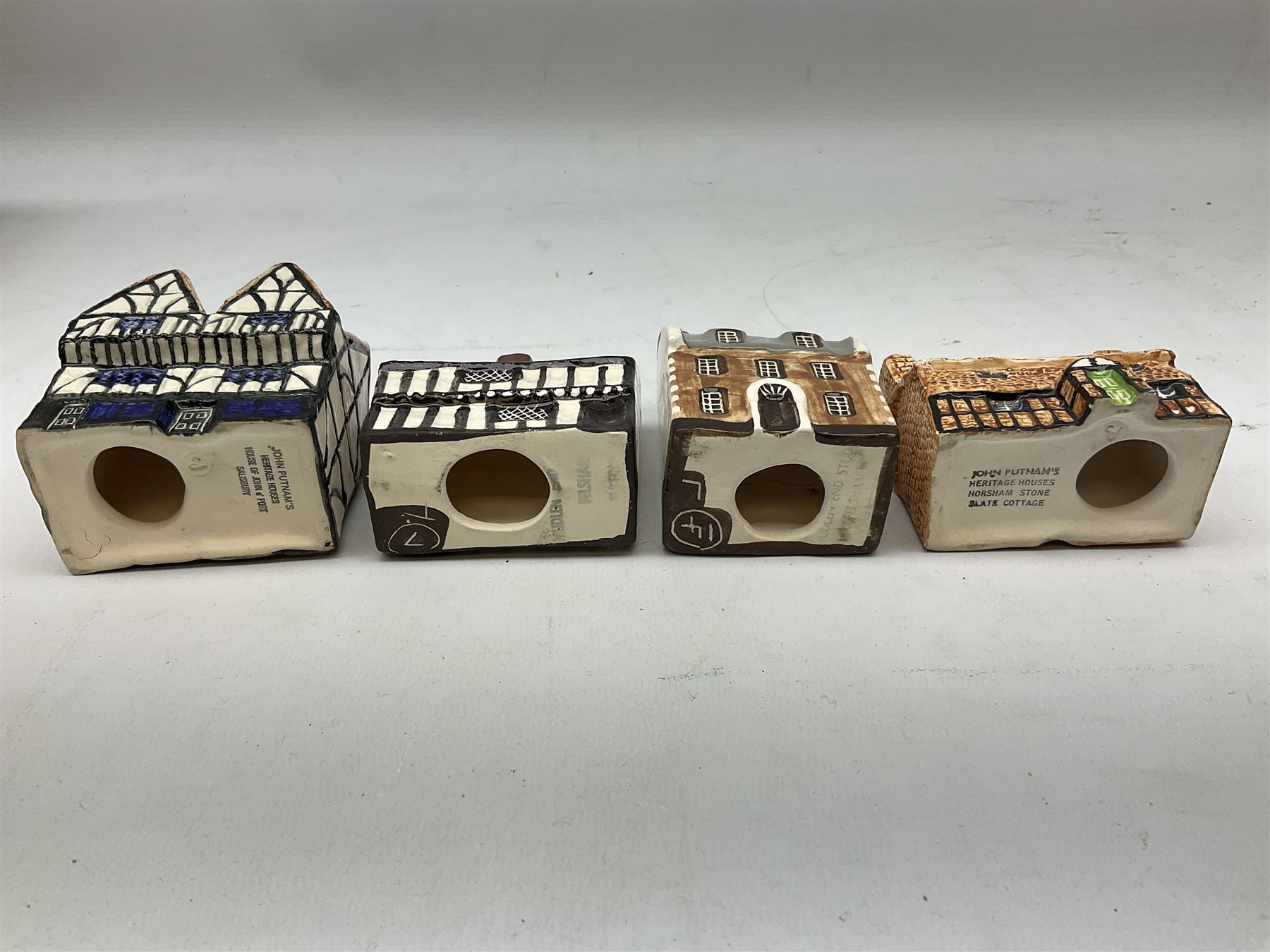 Twenty studio pottery figures of houses and cottages, comprising seventeen Mudlen End Studio Felsham Suffolk examples and two John Putman's Heritage Houses examples