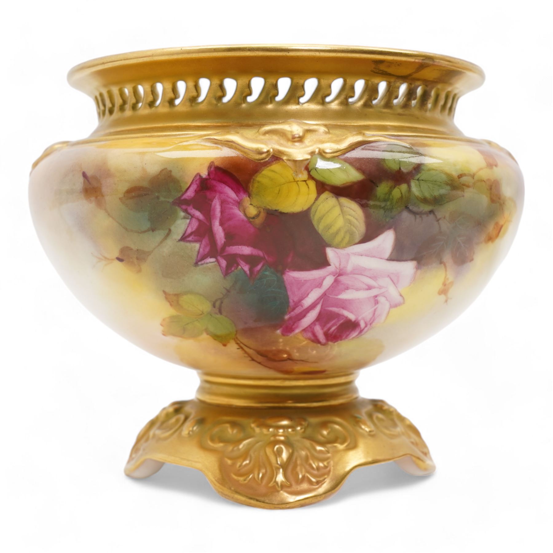 1920s Royal Worcester porcelain rose bowl, the flattened baluster body hand painted with roses and foliage, below a flared gilt pierced border, raised upon scroll moulded quatrefoil foot, shape no. H166, H13cm, together with a similarly decorated Royal Worcester bowl (2)