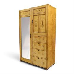 Edwardian Neoclassical figured ash and inlaid double combination wardrobe, the left section with mirrored door enclosing a hanging rail, the right section with cupboard door above four graduated drawers with glass knobs, raised on castors