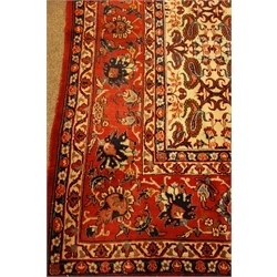 Persian red and beige ground rug, decorated with Herati and Boteh motifs, 310cm x 215cm