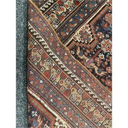 Persian rug, blue ground field decorated with quadruple pole medallion surrounded by animal motifs and stylised flower heads, multiple band border