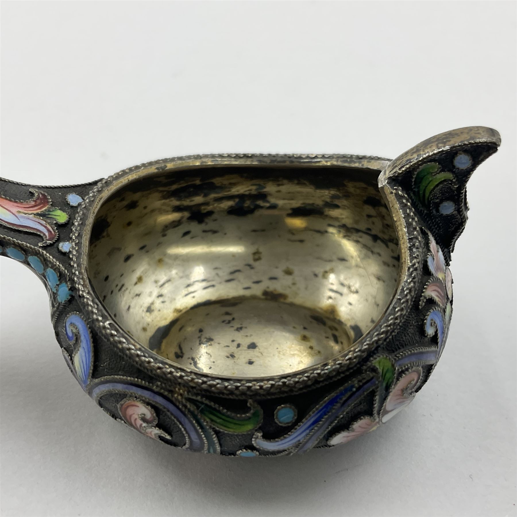 Late 19th century Russian silver kovsh, the body with polychrome cloisonne enamel floral decoration and turquoise enamel bead borders to base and handle, marked beneath with Kokoshnik mark, 84 standard, makers mark MC, possibly for Mikhail Fyodorovich Sokolov, L7cm, H3cm