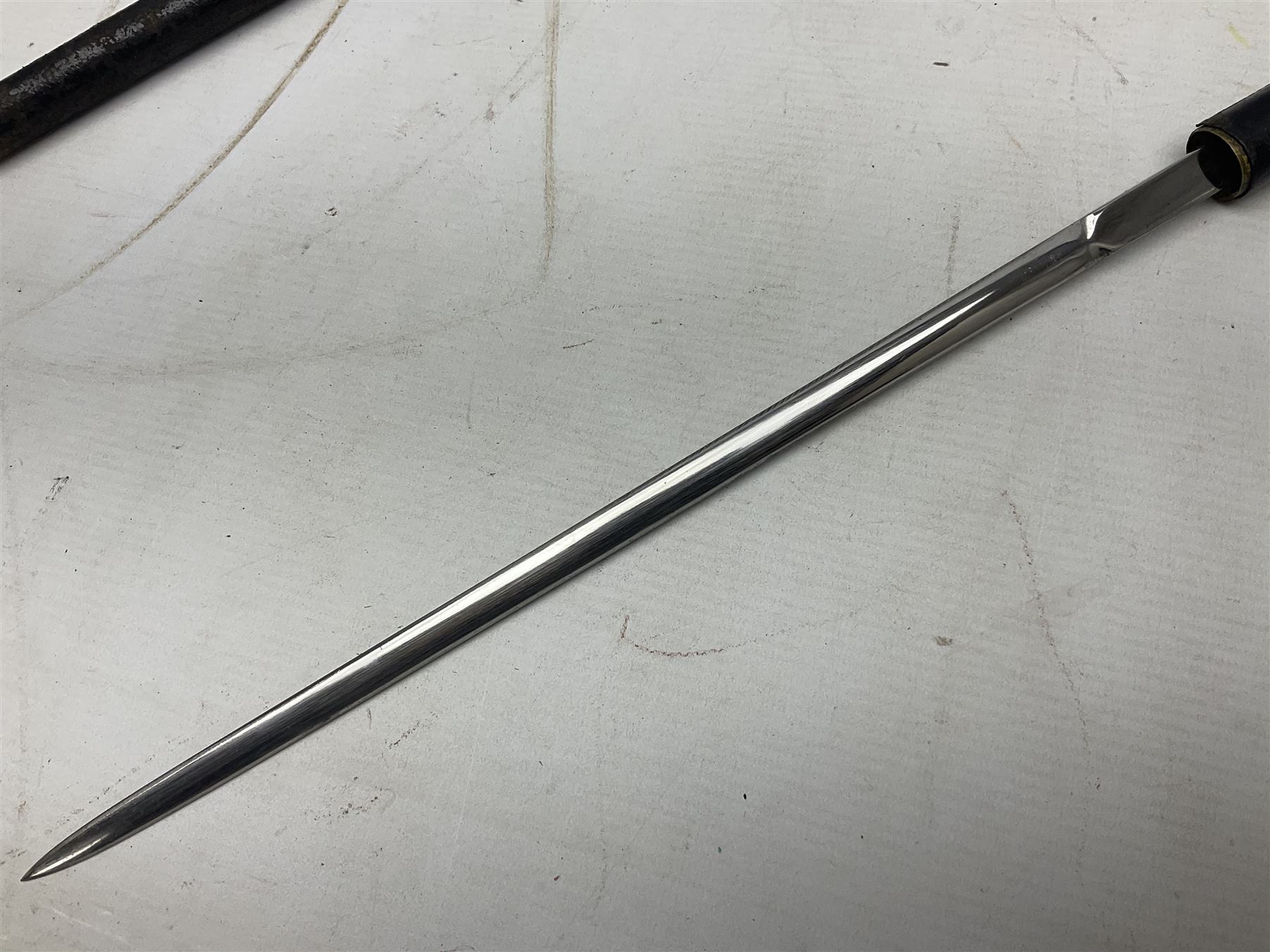 Early 20th century British Army Officer’s leather covered swagger / sword stick by Swaine & Adeney of 185 Piccadilly London; 34.5cm double edged spear point blade with etched foliate decoration and retailer’s details; stamped 'Forged in London' to the edge of the ricasso; L59.5cm overall