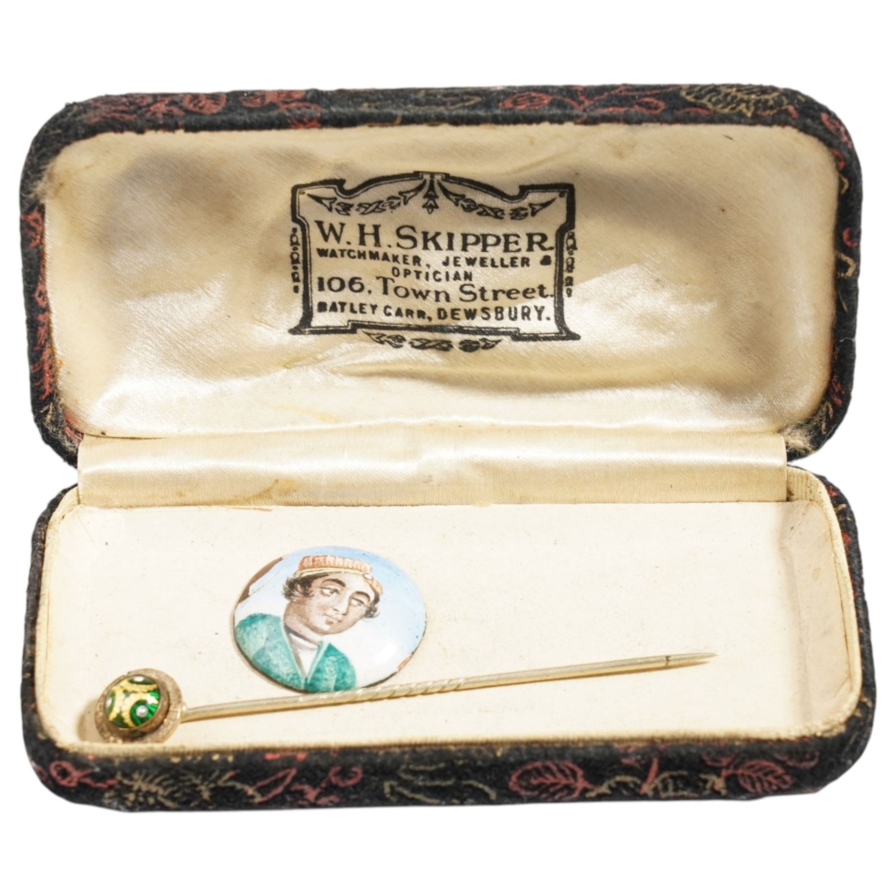 Qajar period enamel plaque depicting a portrait of a young man, D2.1cm, together with a 19th century gilt metal and guilloche enamel stick pin