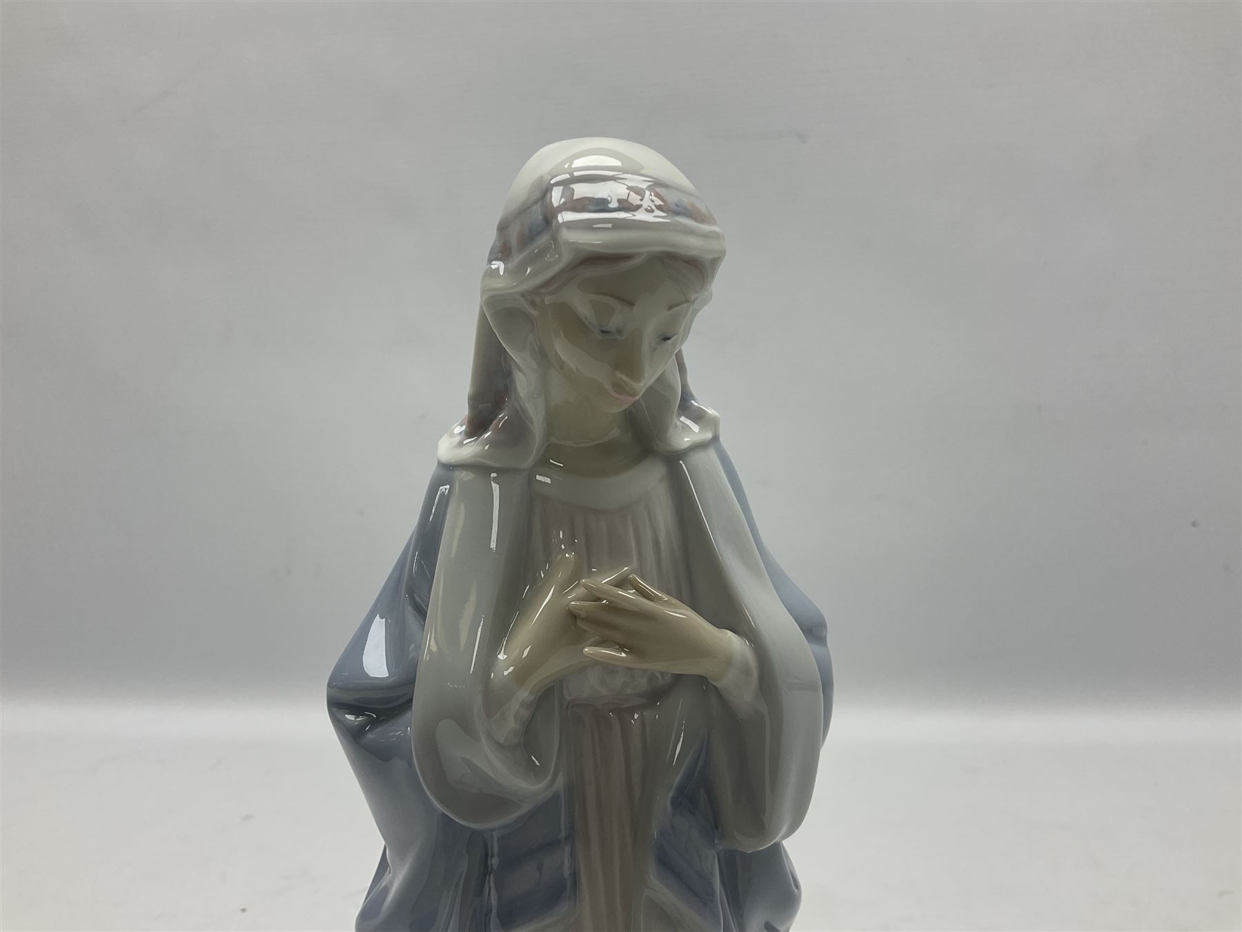Lladro figure, Holy Night, modelled as Mary kneeling over baby Jesus, sculpted by Vincente Martinez, with original box, no 5796, year issued 1991, year retired 1994, H22cm