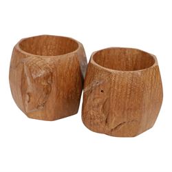 Mouseman - pair of dark oak napkin rings, of bulbous octagonal form with signature mouse carving by Robert Thompson of Kilburn