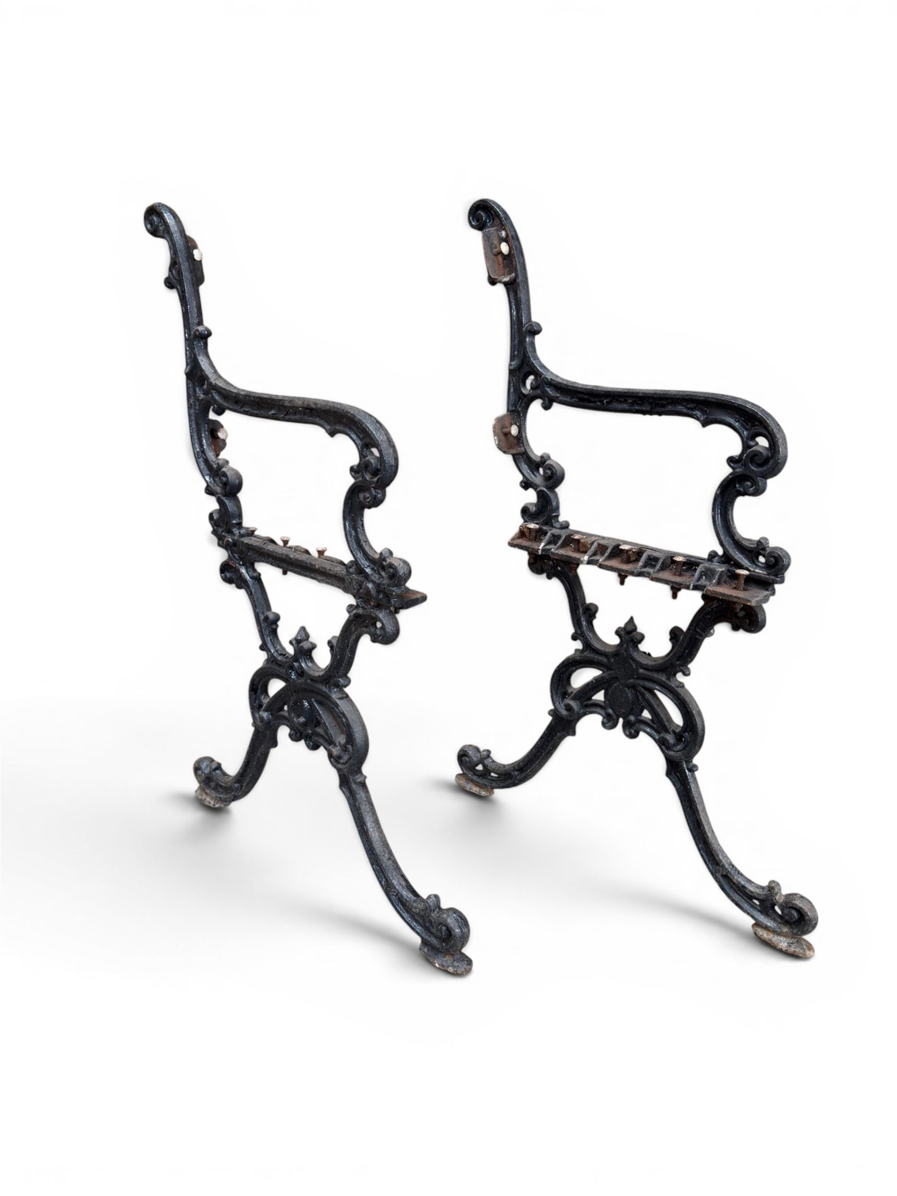 Carron Foundry - two pairs of 19th century cast iron garden bench ends, ornate detail with arms and X shaped legs,finish in black paint, the design no. 110396, first registered 13 July 1857 (see illustration), width as desired