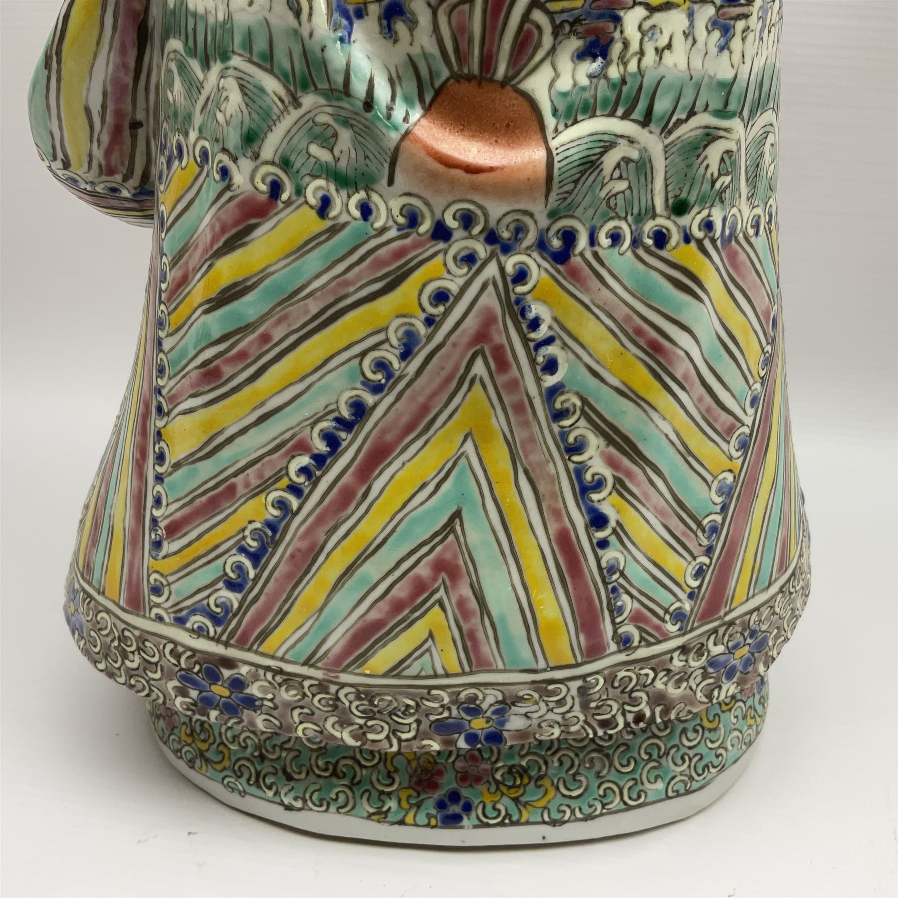 Chinese Republic Period porcelain figure, modelled as Shoulao, wearing elaborately enamelled robes decorated with peaches and flower heads, with impressed mark beneath, H55cm