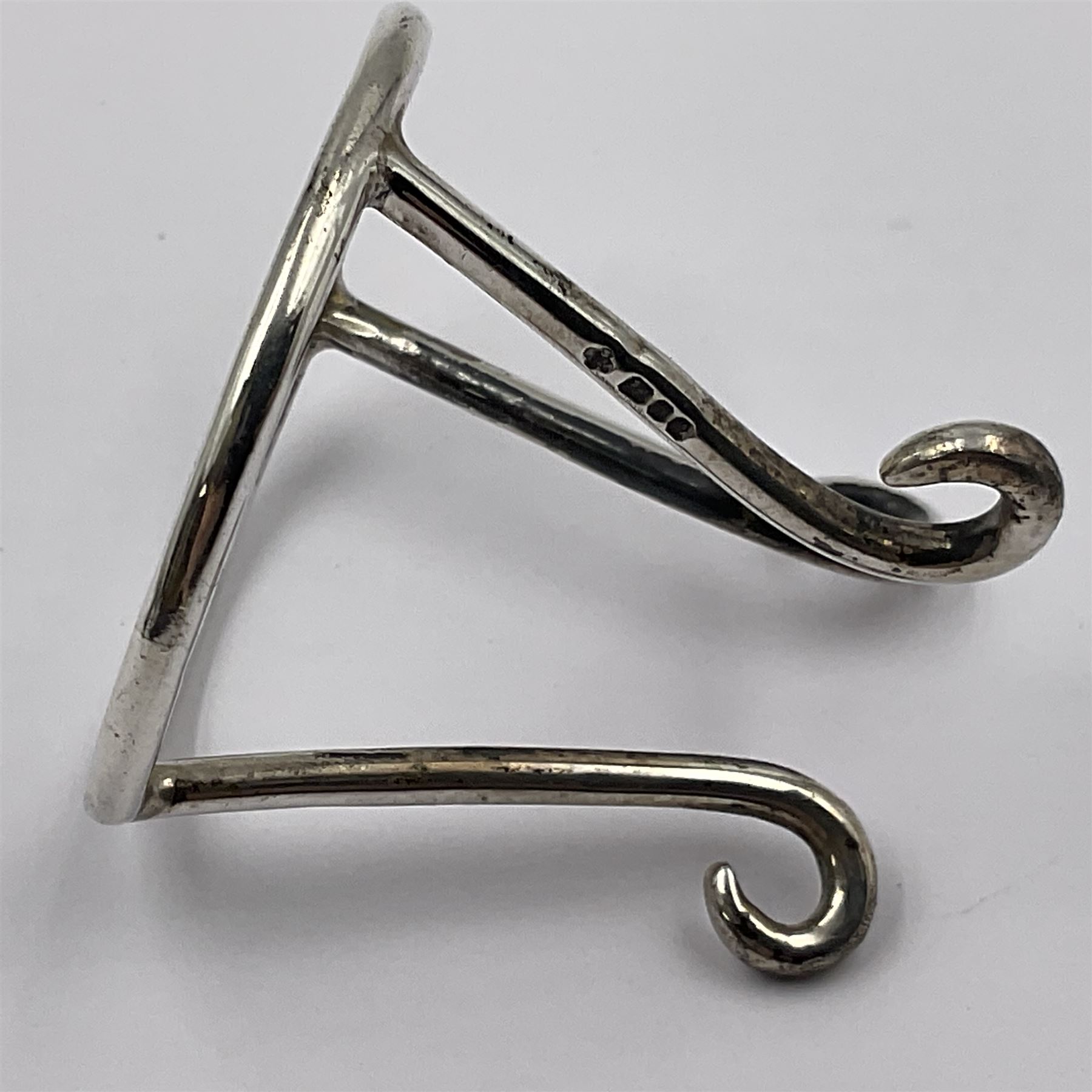 Modern silver limited edition Easter egg, no. 70/500, the openwork lattice body decorated with gilded panels of flower heads, opening to reveal a gilt interior, upon silver stand with three scrolling pad feet, each hallmarked St James House Company, London 1979, height including stand 8cm