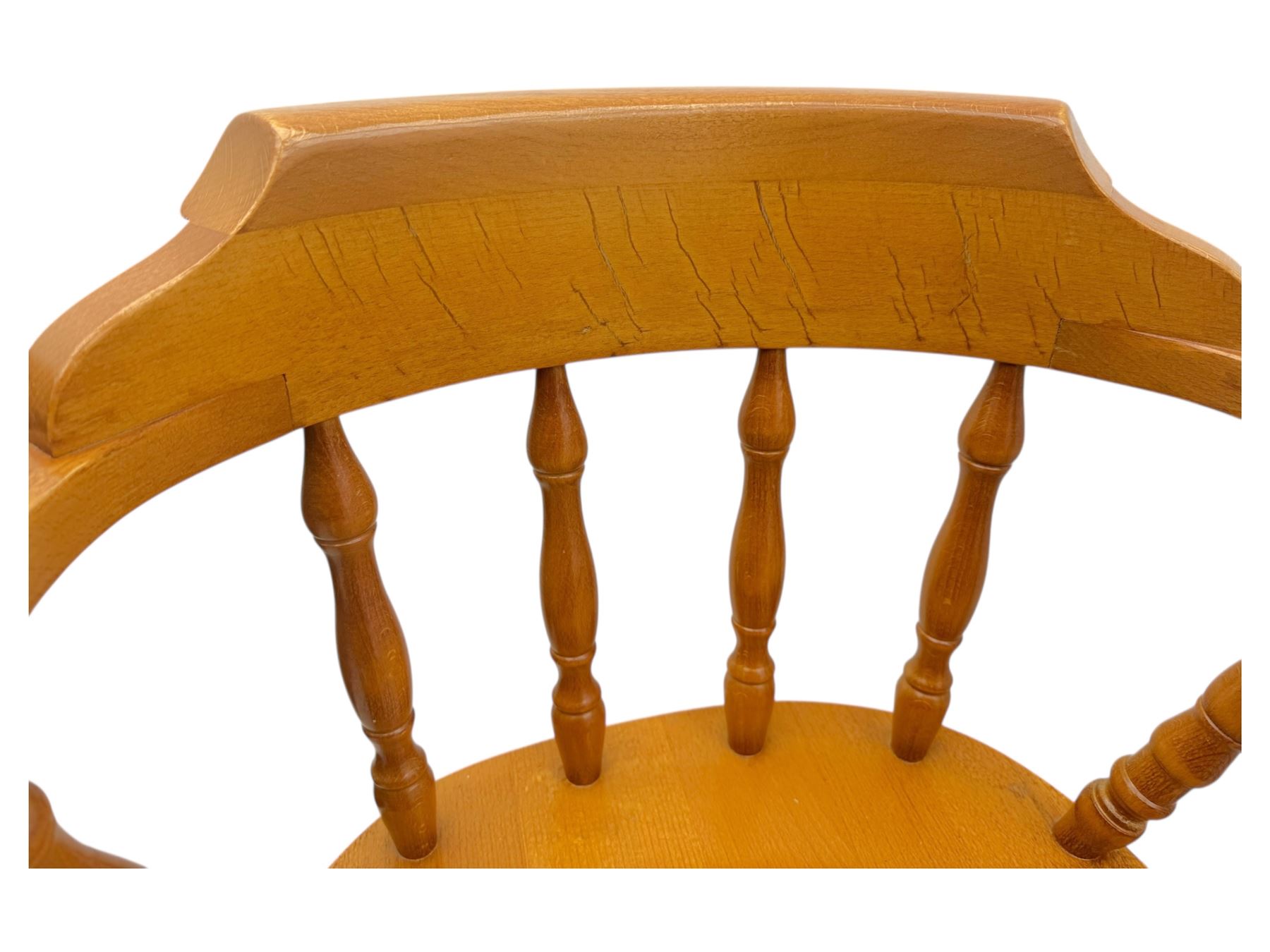 Pair of late 20th century beech bar stools, with curved top rail and turned spindle back, shaped seat over four turned legs united by multiple stretchers