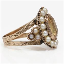 Georgian gold yellow topaz (possibly imperial) and split pearl cluster ring, collect set with a single oval cut foiled back topaz, surrounded by fifteen pearls and pearl set scroll engraved trefoil shoulders